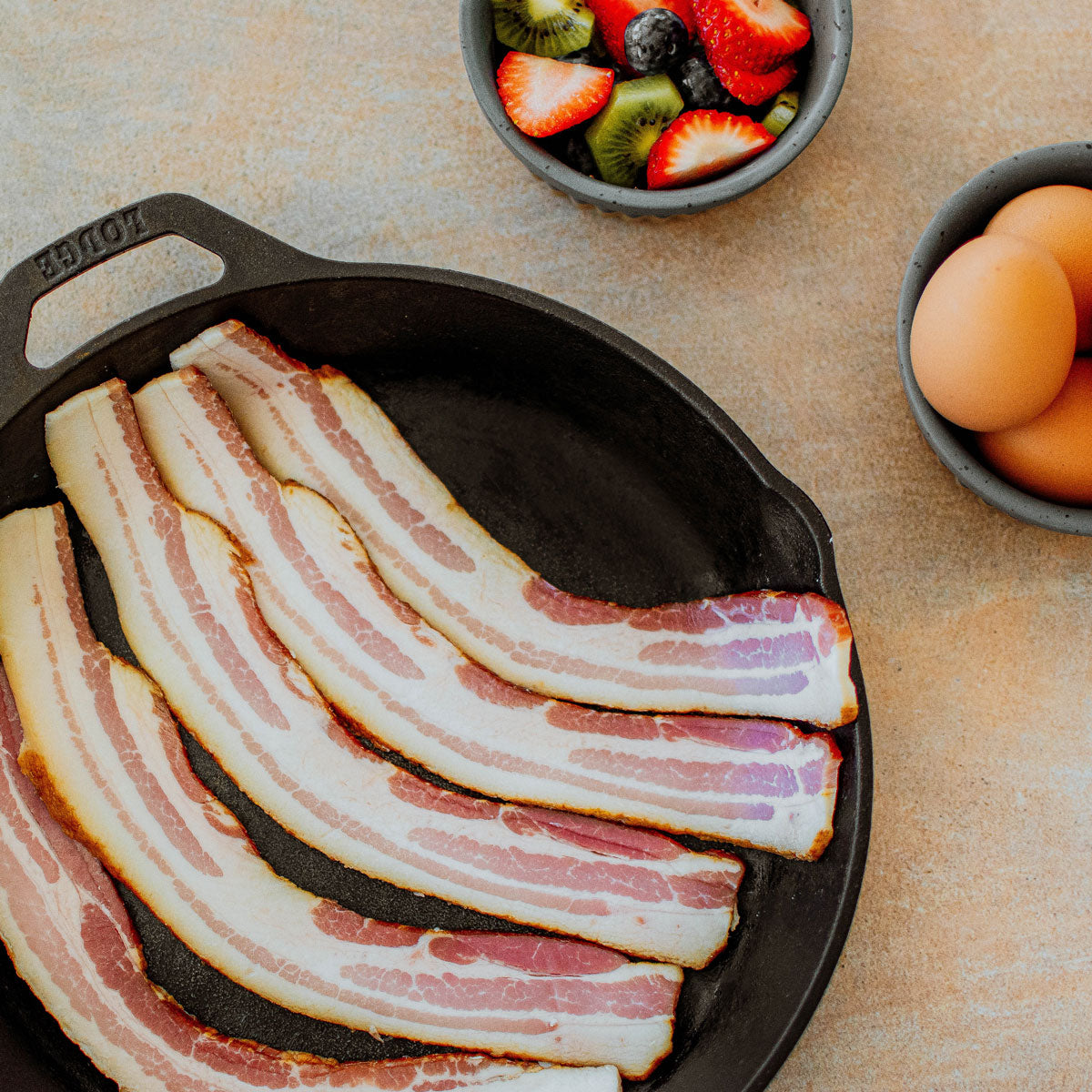 organic pork bacon in a skillet