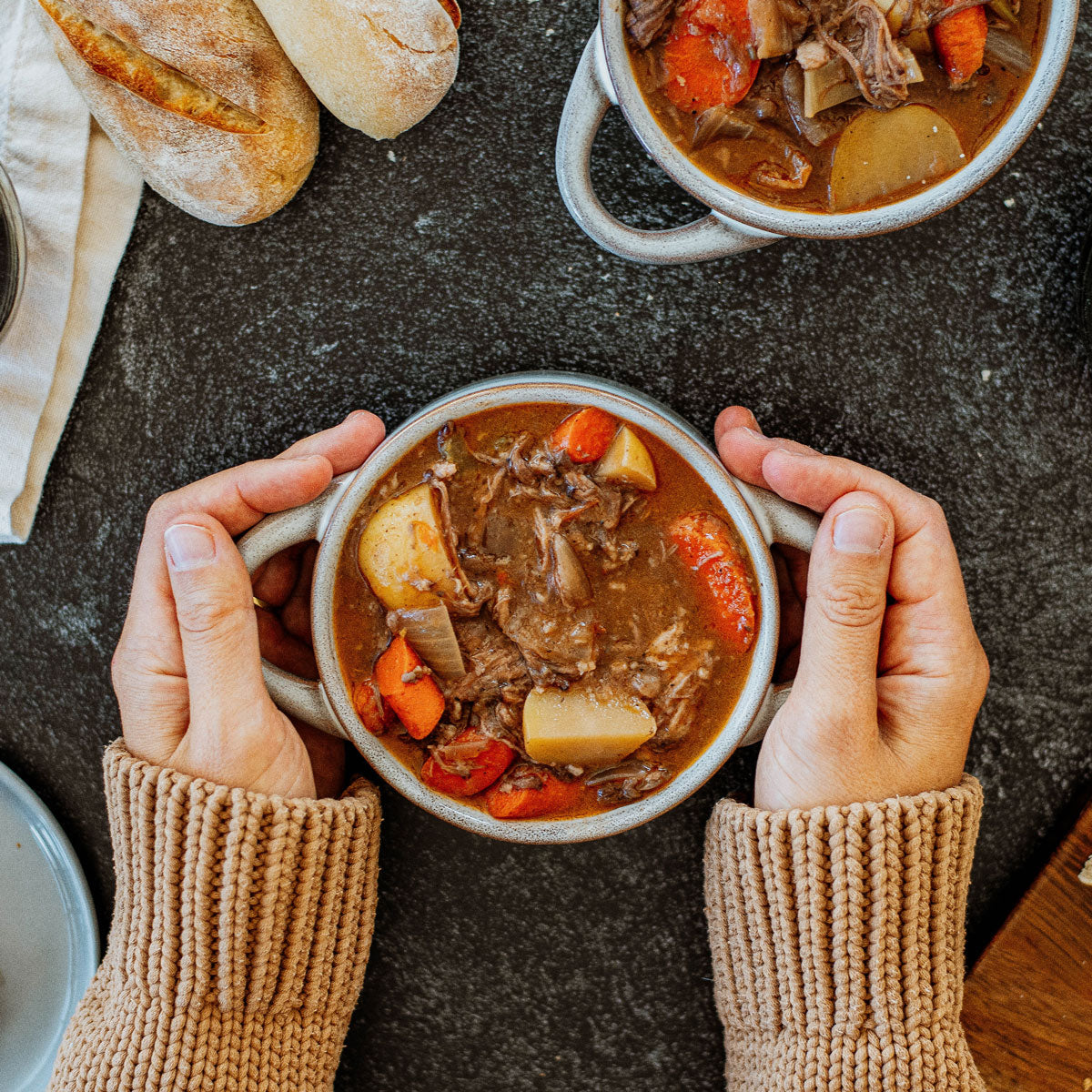 slow cooker beef brisket in a bowl that woman is holding