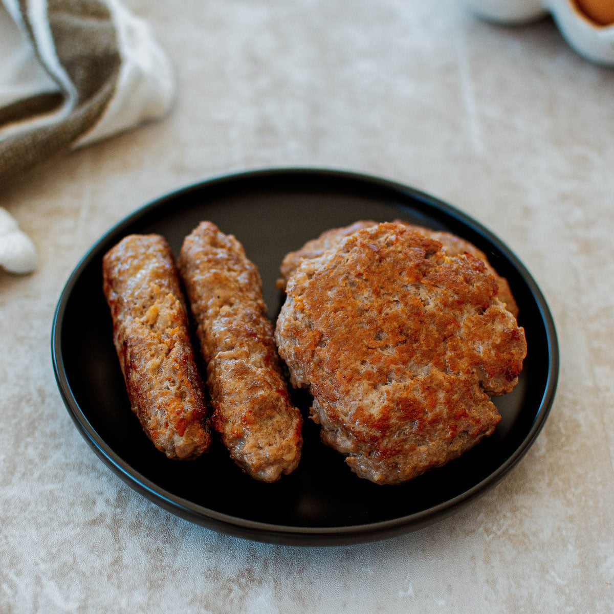 organic pork breakfast sausage links and patties on a plate